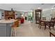 Spacious living room featuring a stone fireplace and wood dining table at 1139 Fairway Dr, Winter Park, FL 32792