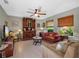 Cozy living room with vintage furniture, a ceiling fan, and natural lighting at 1139 Fairway Dr, Winter Park, FL 32792