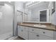 A bathroom featuring a shower and a vanity with white cabinets and a neutral countertop at 1236 S Beach Cir, Kissimmee, FL 34746