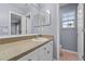 A bathroom featuring a vanity with white cabinets, a mirror, and a view of the toilet at 1236 S Beach Cir, Kissimmee, FL 34746