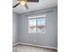 Empty bedroom with gray walls, carpeted floors, a ceiling fan, and a bright window at 1236 S Beach Cir, Kissimmee, FL 34746