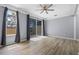 Bright bedroom with light wood flooring and sliding glass doors to a screened lanai at 1236 S Beach Cir, Kissimmee, FL 34746