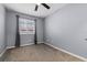 Light-grey bedroom featuring neutral carpet, a window with blinds, and ample natural light at 1236 S Beach Cir, Kissimmee, FL 34746