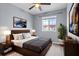 Well-staged bedroom with a wooden bed, side tables, wall art, and natural light at 1236 S Beach Cir, Kissimmee, FL 34746