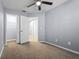 Bedroom with a light-grey wall color and white trim featuring a walk-in closet and an ensuite doorway at 1236 S Beach Cir, Kissimmee, FL 34746