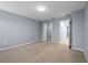 An empty bedroom painted grey with carpeted floor and doorways leading to bathroom and closet at 1236 S Beach Cir, Kissimmee, FL 34746