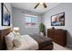 Comfortable bedroom featuring a ceiling fan, a dresser with decor, and a window with neighborhood views at 1236 S Beach Cir, Kissimmee, FL 34746