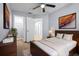 Bedroom featuring modern décor, a ceiling fan, a walk-in closet, and a wooden bed frame at 1236 S Beach Cir, Kissimmee, FL 34746