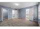 A spacious bedroom with neutral walls, carpeted floor, and adjoining bathroom and closet at 1236 S Beach Cir, Kissimmee, FL 34746