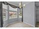 Cozy breakfast nook area illuminated by an elegant chandelier and large windows at 1236 S Beach Cir, Kissimmee, FL 34746