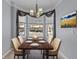 Staged dining area featuring a table with six chairs, chandelier, and bright windows at 1236 S Beach Cir, Kissimmee, FL 34746