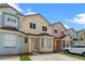 Charming townhomes with colorful facades, brown tile roofs, and well-maintained landscaping at 1236 S Beach Cir, Kissimmee, FL 34746