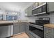 Kitchen featuring stainless steel appliances, grey cabinets, and tile backsplash at 1236 S Beach Cir, Kissimmee, FL 34746