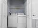 Convenient laundry room with a white washer and dryer inside of a closet space at 1236 S Beach Cir, Kissimmee, FL 34746