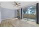 Spacious living room with wood floors, neutral walls, ceiling fan and a sliding glass door at 1236 S Beach Cir, Kissimmee, FL 34746