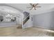 Open-concept living room with wood floors, stylish lighting and kitchen access at 1236 S Beach Cir, Kissimmee, FL 34746