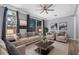 Inviting living room with plush seating, decorative art, and a ceiling fan at 1236 S Beach Cir, Kissimmee, FL 34746
