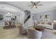 Bright living room with kitchen access, wood floors, stairway and modern furniture at 1236 S Beach Cir, Kissimmee, FL 34746