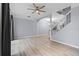 Open-concept living room with hardwood floors, and staircase at 1236 S Beach Cir, Kissimmee, FL 34746
