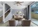 Living room with wood floors, ceiling fan, stairway, neutral decor and sliding glass doors at 1236 S Beach Cir, Kissimmee, FL 34746