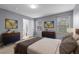 A staged main bedroom featuring stylish decor, a comfortable bed, and neutral colors at 1236 S Beach Cir, Kissimmee, FL 34746