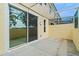 Covered patio featuring stucco walls, white trim, concrete flooring, and sliding glass door access at 1236 S Beach Cir, Kissimmee, FL 34746