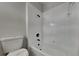 Bright white bathroom with modern fixtures, a soaking tub, and tiled walls at 130 Circle Hill Rd, Sanford, FL 32773