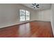 Spacious bedroom featuring hardwood floors and a window overlooking the pool area at 130 Circle Hill Rd, Sanford, FL 32773