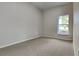 A cozy bedroom featuring neutral tones and a bright window at 130 Circle Hill Rd, Sanford, FL 32773