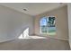 Bright bedroom with neutral carpet and a large arched window, providing great natural light at 130 Circle Hill Rd, Sanford, FL 32773