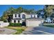 Charming two-story home with a manicured lawn and a two-car garage at 130 Circle Hill Rd, Sanford, FL 32773
