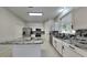 Modern kitchen with an island, granite countertops, stainless steel appliances, and white cabinets at 130 Circle Hill Rd, Sanford, FL 32773