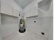 Functional laundry area featuring cabinets, shelving, and water heater at 130 Circle Hill Rd, Sanford, FL 32773
