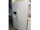 Side-by-side refrigerator/freezer with water and ice dispenser and white finish at 130 Jasmine Woods Ct # 6D, Deltona, FL 32725