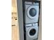 Efficient stacked washer and dryer unit, optimizing space in the laundry area at 130 Jasmine Woods Ct # 6D, Deltona, FL 32725