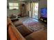 Comfortable living room with stylish rug and sliding glass doors to a balcony at 130 Jasmine Woods Ct # 6D, Deltona, FL 32725