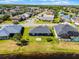 Aerial view of home in a lakeside community with well-maintained lawns, mature trees, and serene water views at 13606 Summer Rain Dr, Orlando, FL 32828