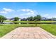 Water view from the backyard patio of home with lush green grass, landscaping and blue skies at 13606 Summer Rain Dr, Orlando, FL 32828