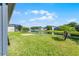 A serene backyard view with palm trees overlooking a tranquil lake, perfect for relaxation at 13606 Summer Rain Dr, Orlando, FL 32828