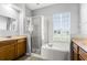 Bathroom features a tub, shower, and double sink vanity at 13606 Summer Rain Dr, Orlando, FL 32828