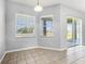 Bright dining room featuring two windows and sliding glass doors to the patio at 13606 Summer Rain Dr, Orlando, FL 32828