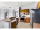 Kitchen boasts stainless steel appliances, wood cabinets, and breakfast bar at 13606 Summer Rain Dr, Orlando, FL 32828