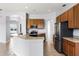 Well-equipped kitchen featuring wood cabinets, stainless steel appliances, and breakfast bar at 13606 Summer Rain Dr, Orlando, FL 32828