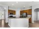 Open kitchen with stainless steel appliances, breakfast bar and wood cabinets at 13606 Summer Rain Dr, Orlando, FL 32828