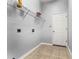 Laundry room with storage shelf, tiled floors, and washer/dryer hookups at 13606 Summer Rain Dr, Orlando, FL 32828