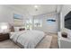 Bright main bedroom with a king bed, ensuite bath, and calming decor at 13606 Summer Rain Dr, Orlando, FL 32828