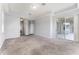 Large main bedroom boasts carpet, tray ceilings, access to a lanai, and an ensuite bath at 13606 Summer Rain Dr, Orlando, FL 32828