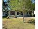 Charming single-story home featuring a well-maintained lawn and cozy front porch, perfect for relaxing outdoors at 1404 Davidson St, Orlando, FL 32804