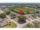 An aerial view shows the home is nestled in a serene neighborhood with mature trees and green spaces at 150 Bentley Oaks Blvd, Davenport, FL 33896