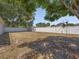 Expansive backyard featuring a well-maintained lawn, privacy fence, and mature trees at 150 Bentley Oaks Blvd, Davenport, FL 33896